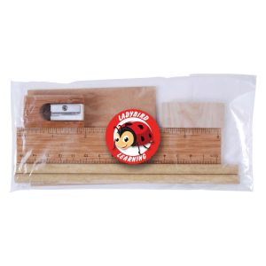 A clear package containing a wooden ruler, two wooden sticks, a sharpener, and an eraser featuring a cartoon character.