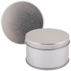 A silver round tin with a smooth finish and a removable lid, positioned upright next to its lid.