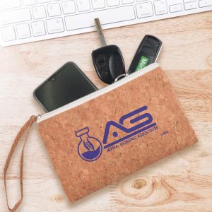 A cork utility case featuring a logo, with a smartphone, car keys, and a key fob visible inside.