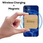 A hand holding a square bamboo wireless charger with a logo, surrounded by charging graphics on a blue phone.