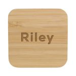 A bamboo wireless charger with a smooth, natural finish and rounded edges. It features a logo on the surface.