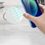 A white magnetic wireless charging stand with a smartphone being positioned above it, showcasing its charging feature.