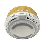 A wireless charging speaker with a bamboo exterior and a white base, featuring buttons on top and a port for charging.