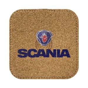 A square cork wireless charger with a logo printed in blue and red, featuring a lion design and the word "SCANIA".