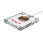 A clear acrylic wireless charger with a circular charging pad and a logo on its surface.