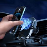 A wireless car charger in silver, holding a smartphone with a blue charging symbol, set against a dark background.