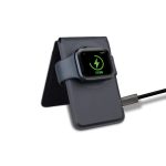 A grey magnetic card wallet and wireless charging stand with a smartwatch resting on it, connected by a charging cable.