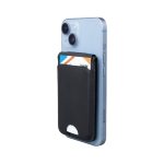A black magnetic card wallet attached to a light blue smartphone, holding a card in its slot.