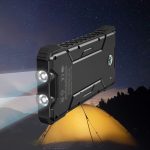 A black solar power bank with dual lights, set against a night sky and a camping tent.