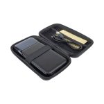 A black wireless power bank with a protective case and a charging cable inside.