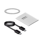 A magnetic wireless charging station in black, featuring a USB cable, user manual, and a circular magnetic plate.