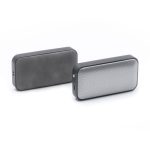 A pair of compact wireless speakers in black and silver, featuring a mesh grille and a sleek design.