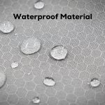 A close-up of waterproof material with water droplets on a textured, hexagonal pattern in light grey.