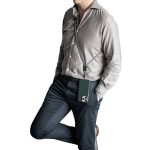A green crossbody phone strap attached to a phone, worn by a person in a light grey shirt and dark trousers.