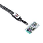 A black and white patterned phone strap with a clip and a transparent card holder featuring a colourful graphic inside.