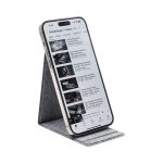 A smartphone on a grey wireless charger stand, displaying a video streaming interface. The stand has a sleek design.