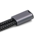 A black and grey braided wristband strap with a metallic grey connector, featuring a logo.