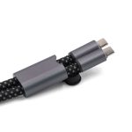 A charging cable with dual connectors, featuring a black braided design and a metallic grey holder.