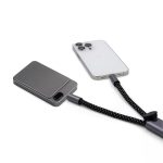 A grey eco-friendly phone strap with a connecting charging cable attached to a smartphone.