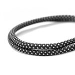 A charging cable in black with a white braided design, coiled elegantly on a white background.