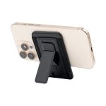 A phone with a black stand attached to the back, featuring a textured exterior. The phone is gold in colour.