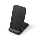 A black wireless charger with a sleek, angled design and a small base for stability.
