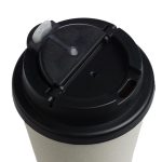 A reusable coffee cup in a light color with a black comfort lid and a small opening for sipping.
