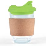 A reusable coffee cup with a transparent body, green snap lid, and a cork band around its middle.
