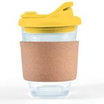 A reusable coffee cup featuring a transparent design, a yellow snap lid, and a cork band for grip.