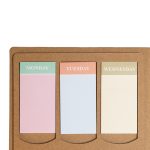 A planner with three colored tabs for Monday, Tuesday, and Wednesday, set against a brown kraft background.