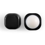 A black cube-shaped lip balm container with a white balm center, featuring a sleek design and logo.
