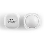 A square, white lip balm container with a rounded top and a logo on the lid. The balm appears smooth and white inside.