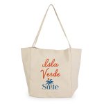 A cream-coloured tote bag featuring a logo and the text "Isla Verde". It has long handles for carrying.