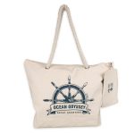 A cream-colored canvas tote bag featuring a nautical design and a rope handle, with a logo attached.