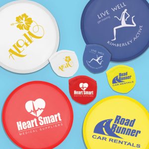 A collection of colorful promotional frisbees in white, blue, red, and yellow, featuring various logos and designs.