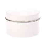 A petite candle in a simple, white tin container with a smooth lid. The tin is cylindrical in shape.