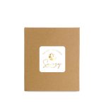 A brown cardboard box featuring a logo with gold accents and sleep-themed graphics.