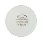 A large white glass candle with a frosted finish and a warning label on the base, featuring natural soy wax.