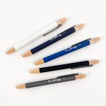 A set of Serenity Aluminium Pens in white, navy, blue, black, and grey, featuring wooden accents and a logo.