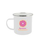 A white enamel mug featuring a colorful donut design and a logo. The mug has a shiny metal rim.