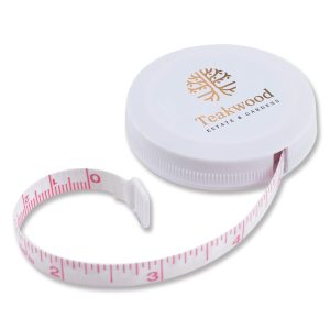 A white circular tape measure with a pink measuring tape extending from it, featuring a logo on the top.