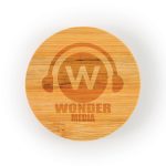 A round bamboo coaster features an engraved logo with the text "WONDER MEDIA" and a headphone graphic.