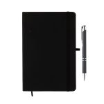 A black notebook with a pen beside it, featuring a logo on the cover. The notebook has an elastic band closure.