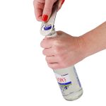 A drink bottle opener in silver is being used to open a bottle with a woman's hand gripping it.