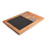 A bamboo cheese board with a slate surface and three stainless steel cheese knives. Features a natural wood finish.