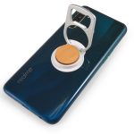 A drink bottle opener attached to a phone with a wooden base, set against a dark blue smartphone.