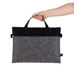 A grey felt satchel with a black top, featuring a zippered closure and dual handles.