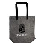 A grey tote bag with black handles and a logo, featuring a minimalist design.