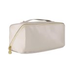 A light beige toiletry bag with a gold zipper and a handle, featuring a logo on the side.