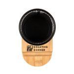A black pen tidy phone stand with a bamboo base, featuring a logo on the front.